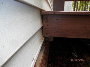 Here you can see the deck was attached to the home without removing the vinyl siding. This area will be more prone to moisture intrusion and deck failure.