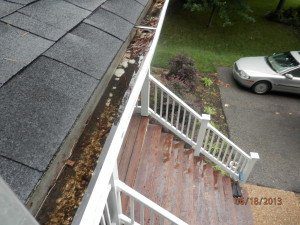 Clogged gutters full of water and debris.