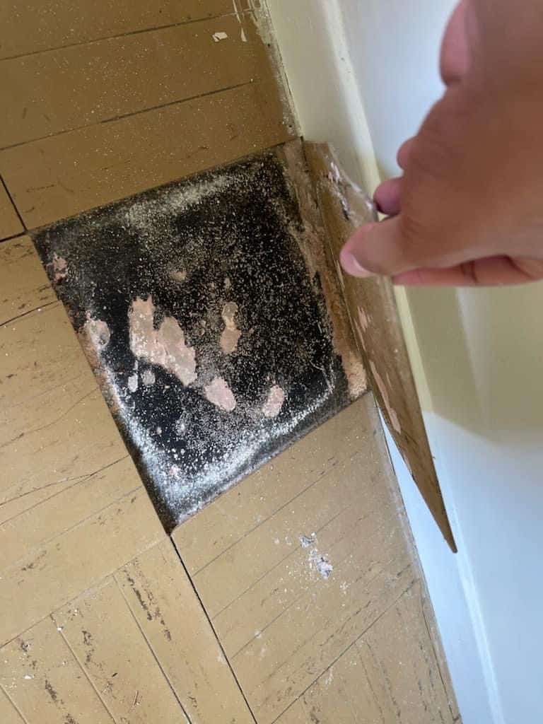 tiles with black sealant likely contain asbestos